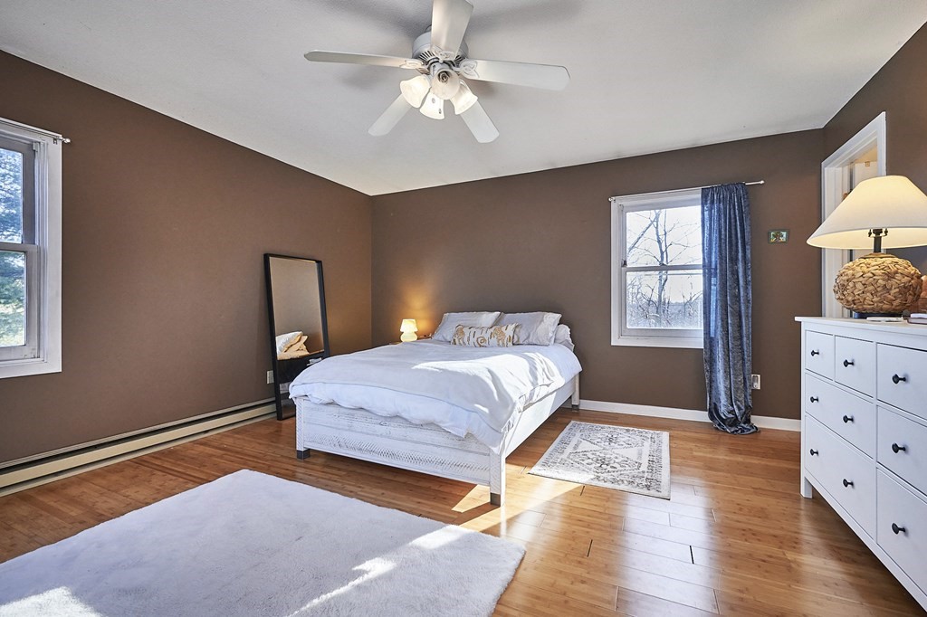 44 Evergreen Road, Unit 301 Leeds, MA 01053 - Photo 13 of 22 a bedroom with a bed and a dresser with mirror