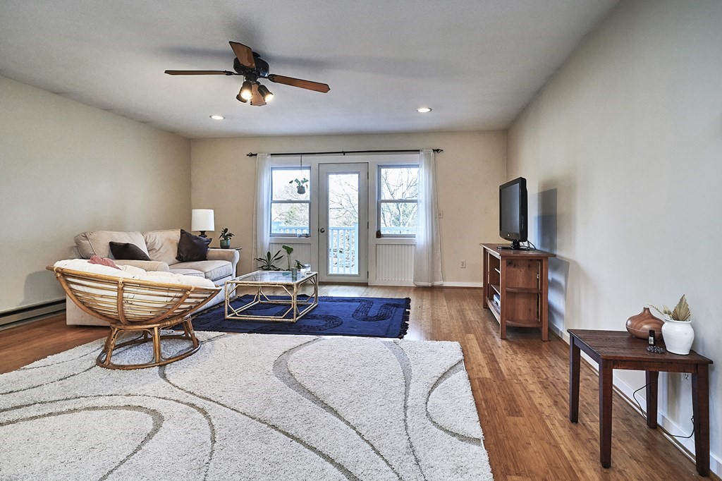 44 Evergreen Road, Unit 301 Leeds, MA 01053 - Photo 4 of 22 a living room with furniture a flat screen tv and a window