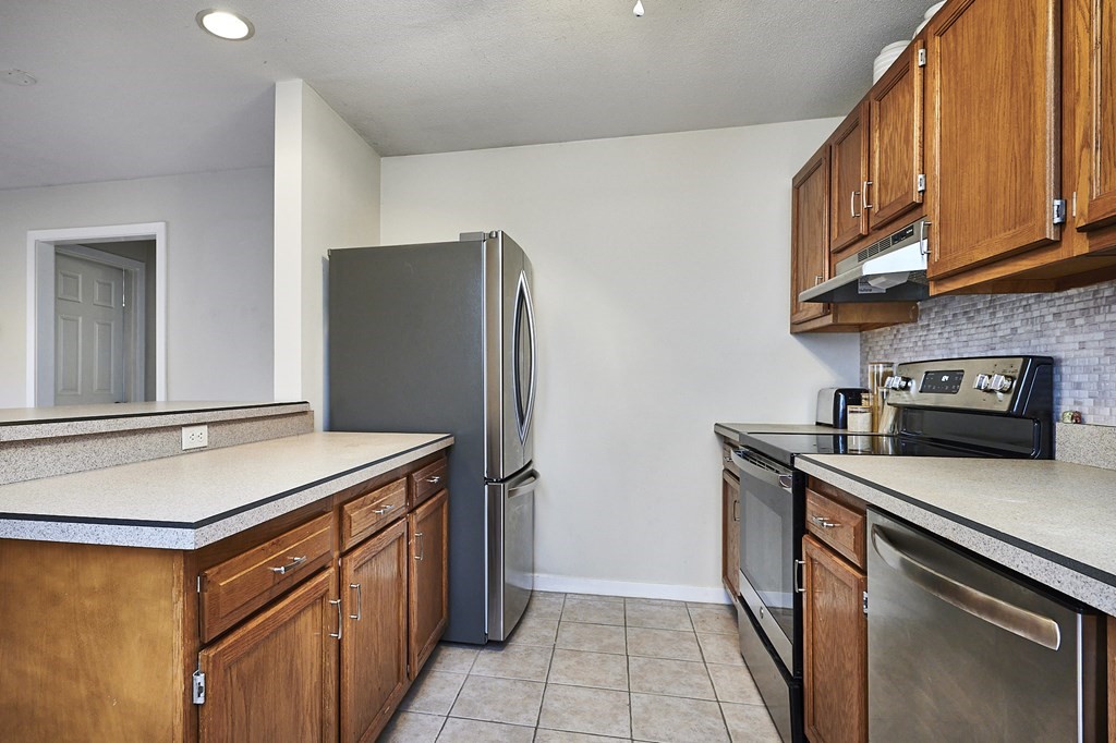 44 Evergreen Road, Unit 301 Leeds, MA 01053 - Photo 8 of 22 a kitchen with stainless steel appliances granite countertop a refrigerator stove and sink
