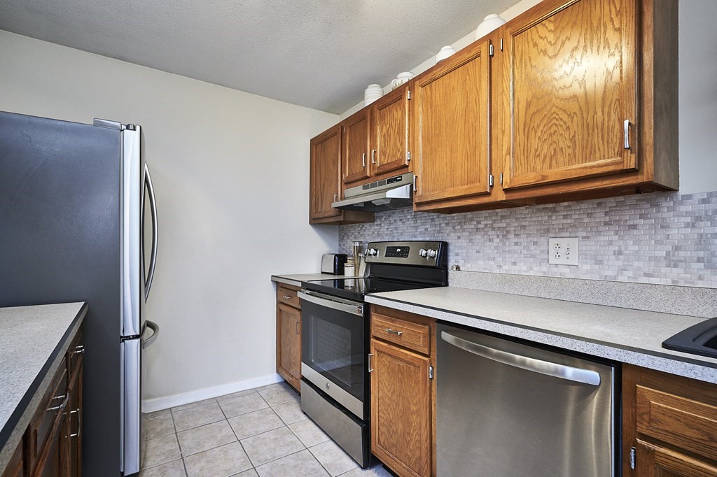 44 Evergreen Road, Unit 301 Leeds, MA 01053 - Photo 9 of 22 a kitchen with stainless steel appliances granite countertop a stove a sink and a microwave