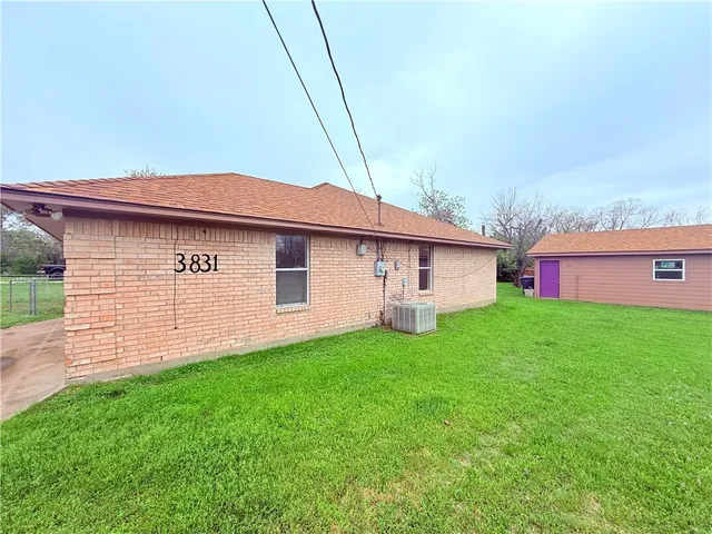 a view of a house with a backyard