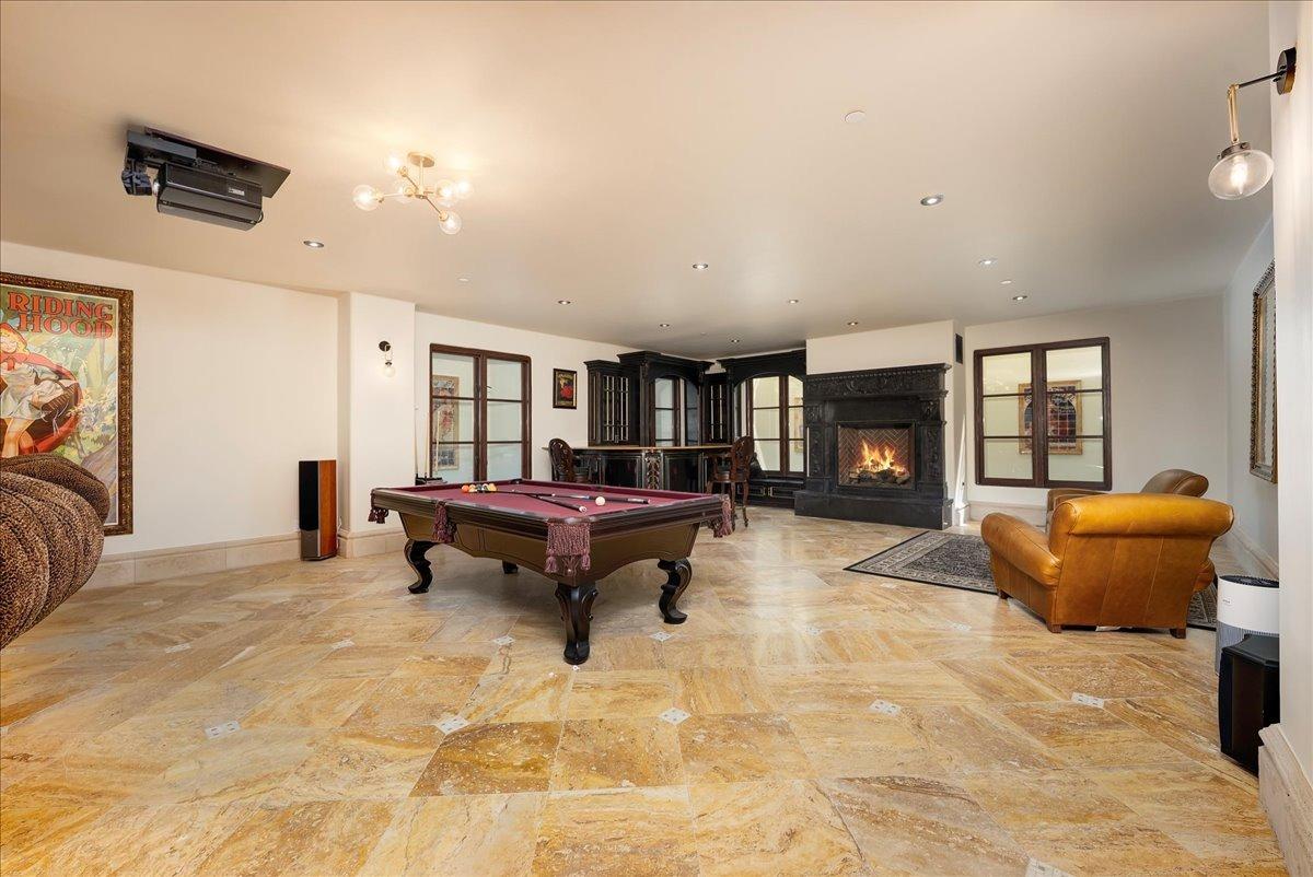 217 Rue Esperanza Lincoln, CA 95648 - Photo 43 of 71 Full bar, stone fireplace and pool table area within underground movie room.