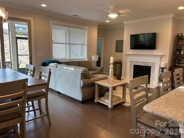 a balcony with furniture and a floor to ceiling window