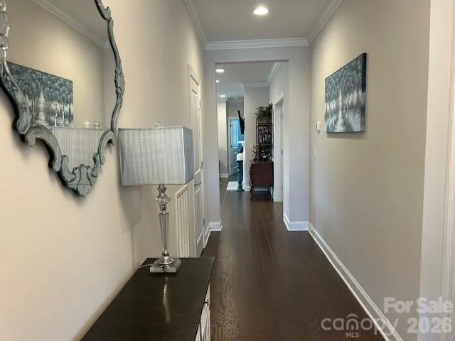 a view of a hallway with wooden floor and stairs