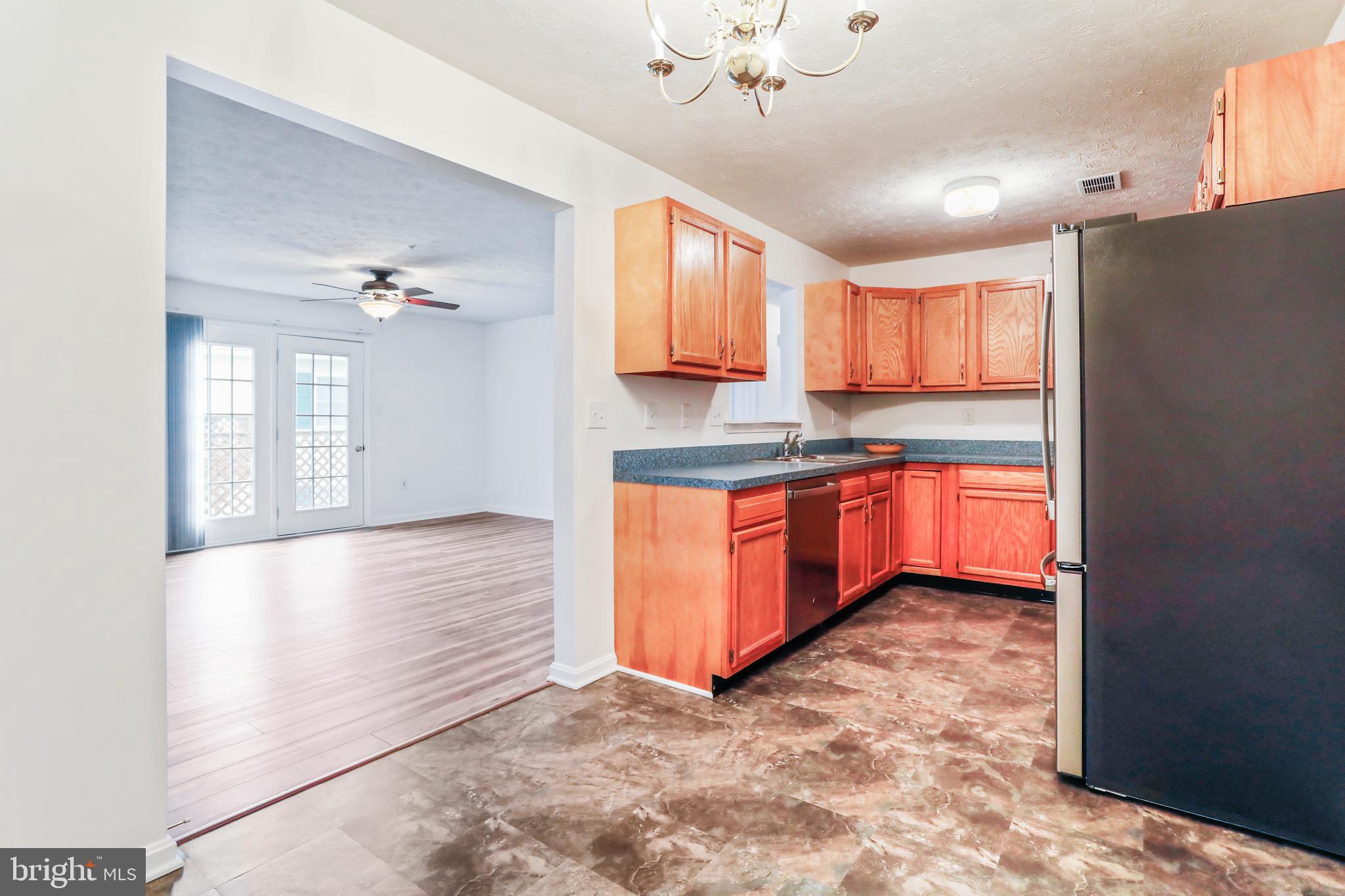 145 Hailey Lane, Unit F11 Strasburg, VA 22657 - Photo 13 of 39 a kitchen with stainless steel appliances granite countertop a refrigerator and a sink