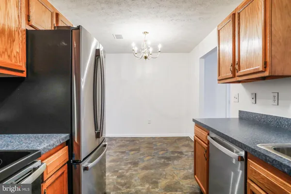 an empty room with windows and cabinet