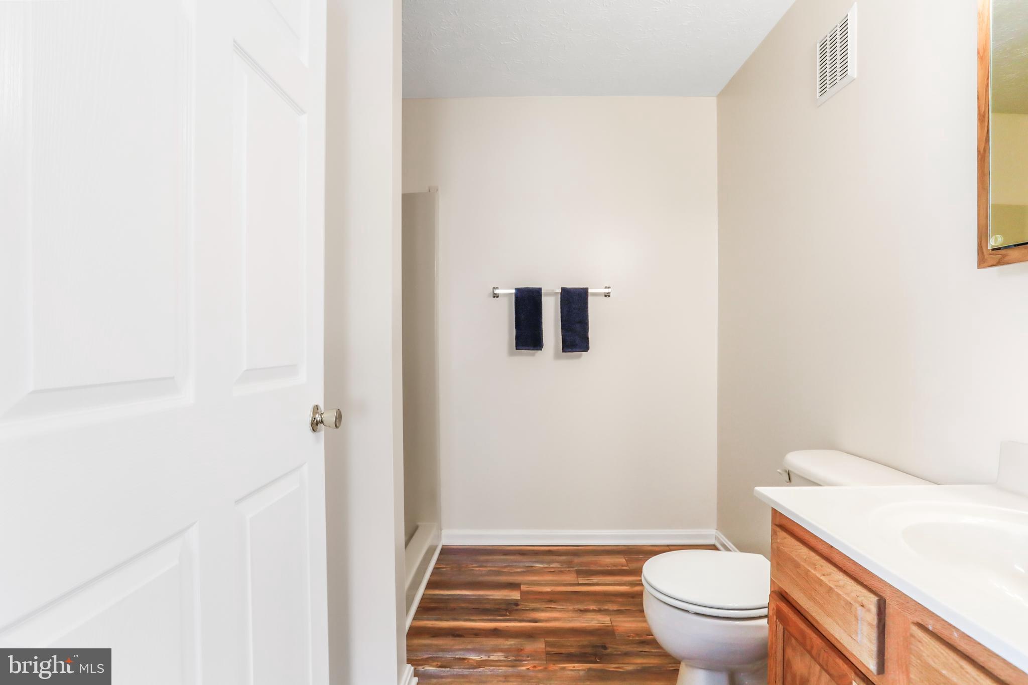 145 Hailey Lane, Unit F11 Strasburg, VA 22657 - Photo 26 of 39 a bathroom with a granite countertop toilet and a sink