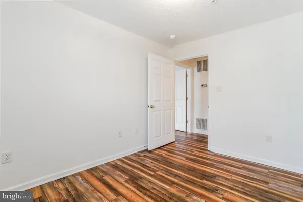 a view of a room with wooden floor and closet