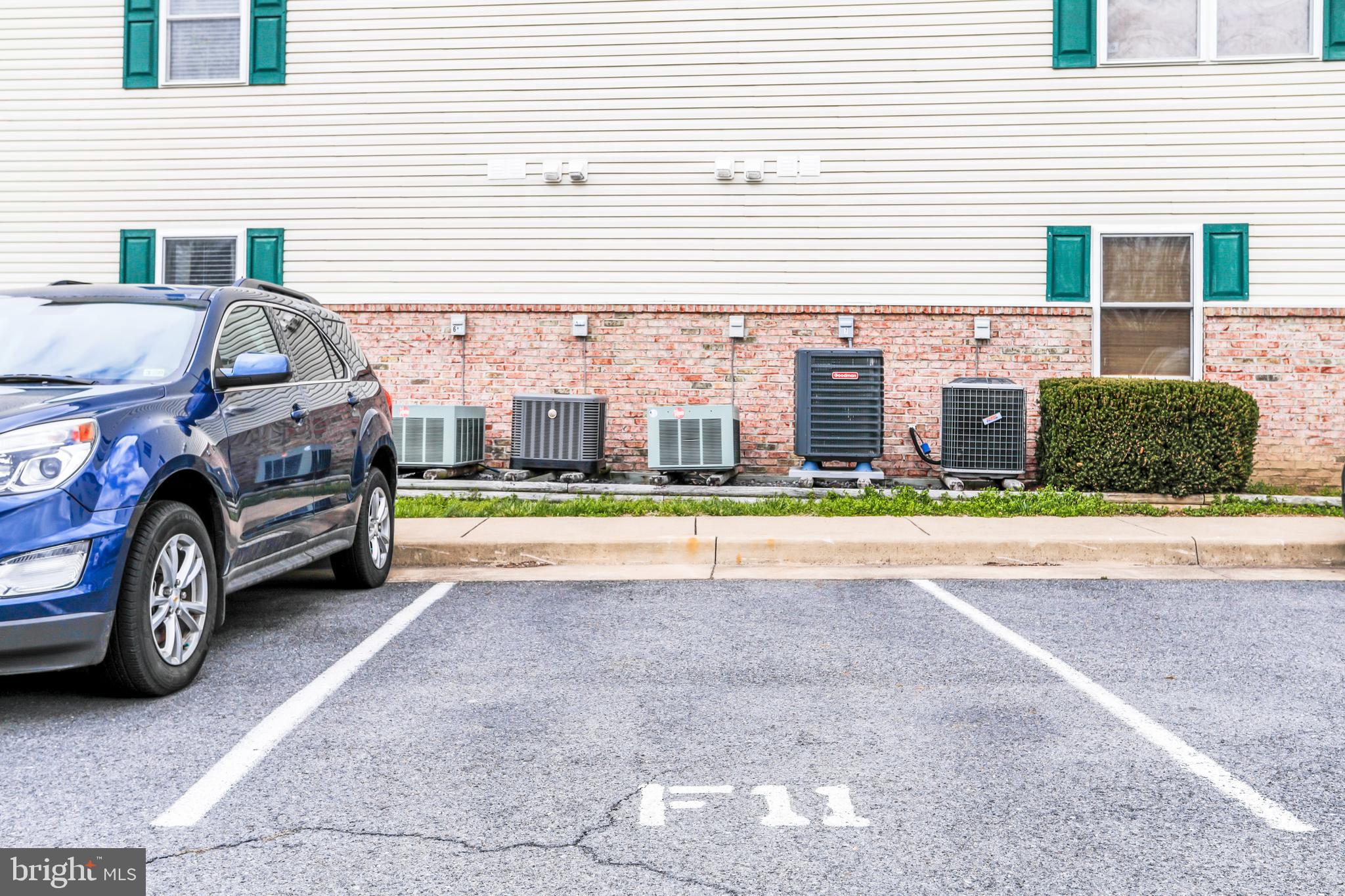 145 Hailey Lane, Unit F11 Strasburg, VA 22657 - Photo 35 of 39 a car parked in front of a white house