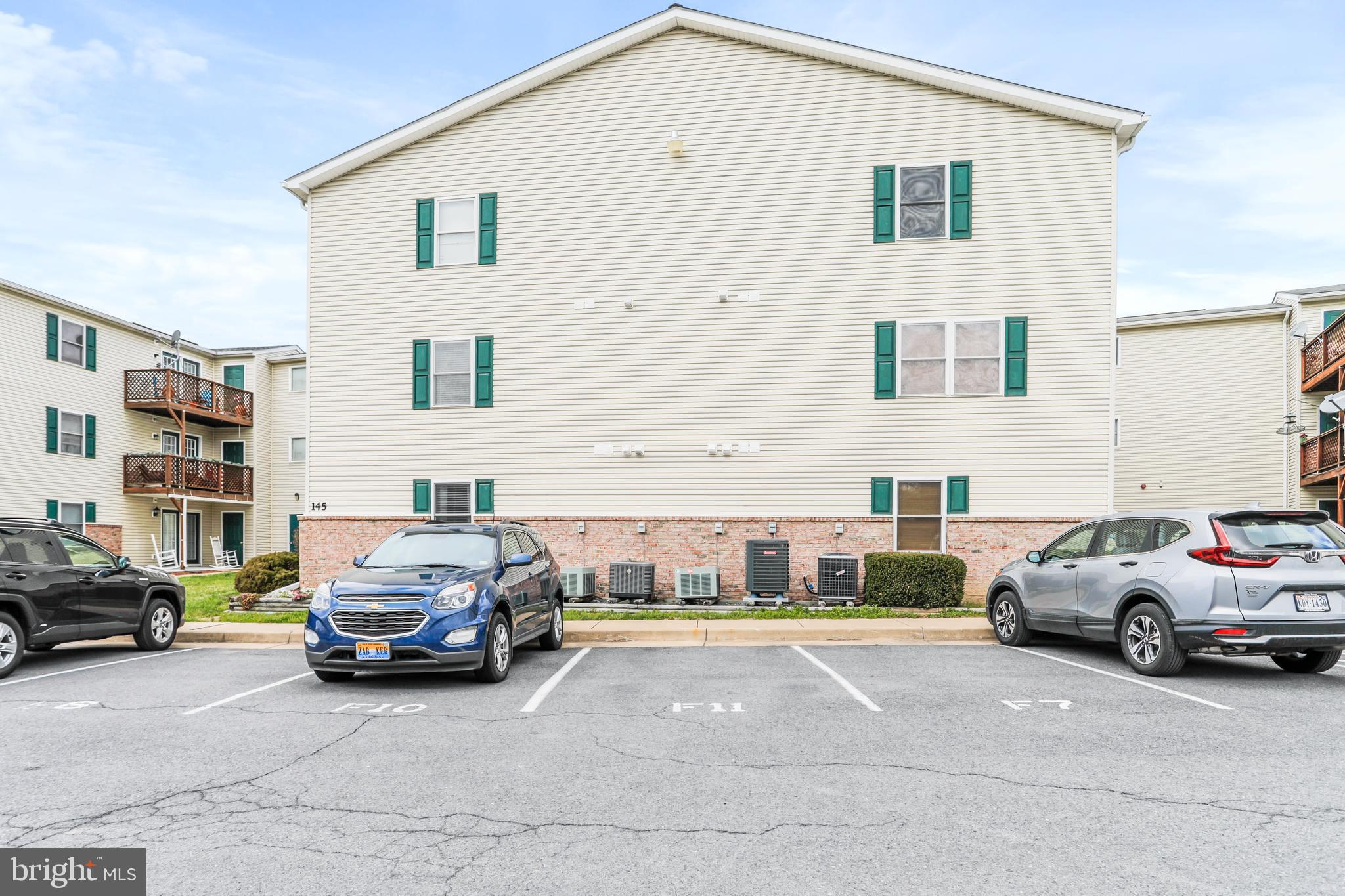 145 Hailey Lane, Unit F11 Strasburg, VA 22657 - Photo 36 of 39 a view of a cars park in front of a house