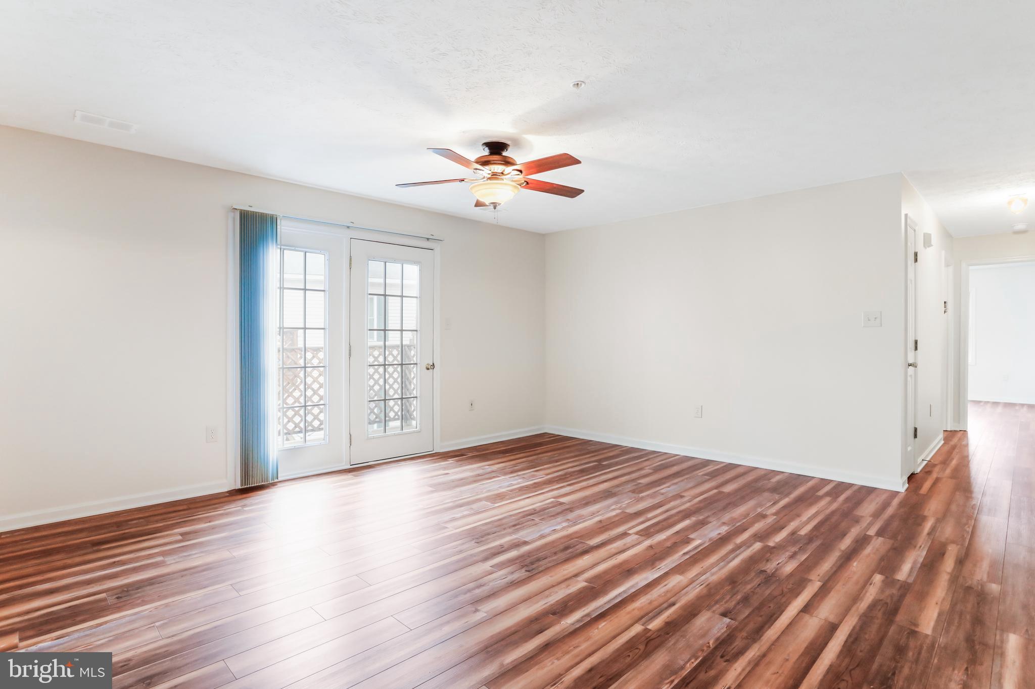 145 Hailey Lane, Unit F11 Strasburg, VA 22657 - Photo 8 of 39 wooden floor in an empty room with a window