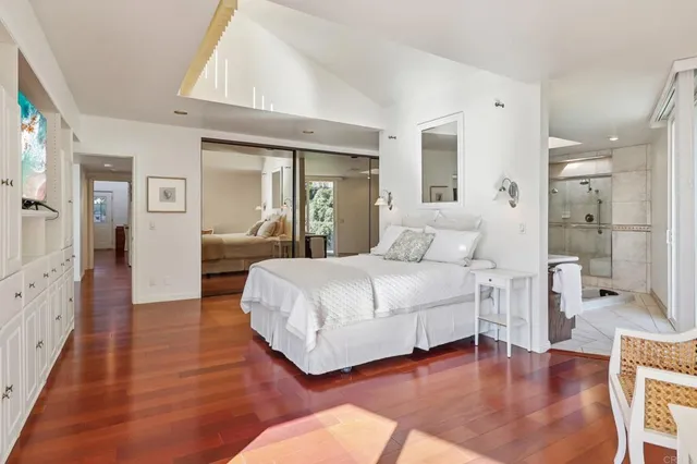 a bedroom with a bed and a large mirror