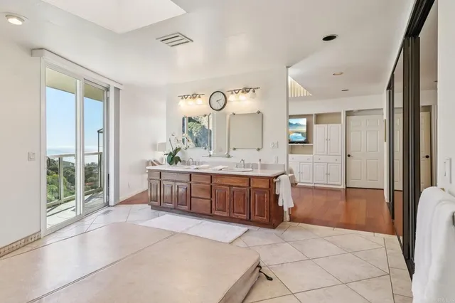 a spacious bathroom with a granite countertop sink mirror and a bath tub