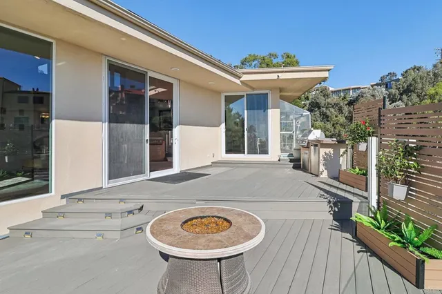 a view of a house with a swimming pool and sitting area