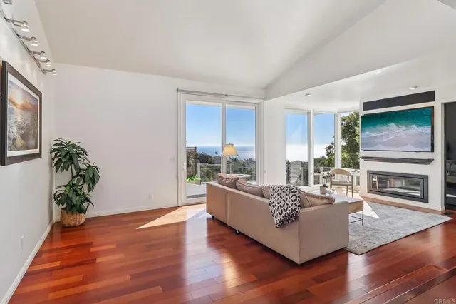 a living room with furniture wooden floor and a flat screen tv