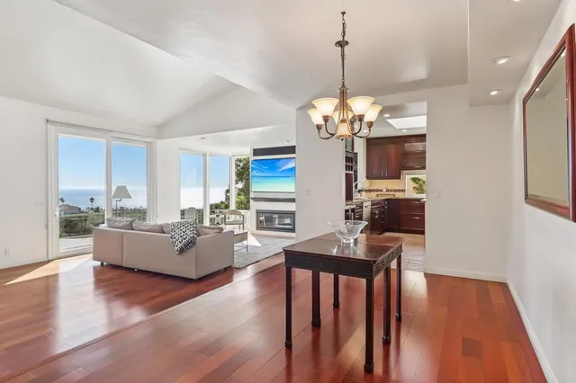 a living room with fireplace furniture and a wooden floor