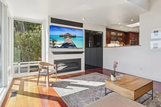 a living room with furniture a rug and a fireplace