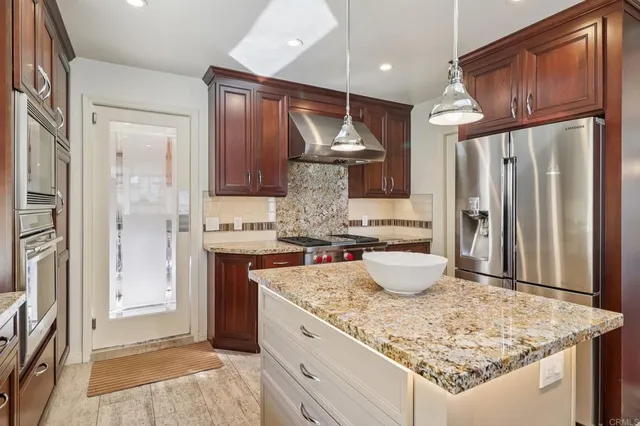 a kitchen with a sink and refrigerator