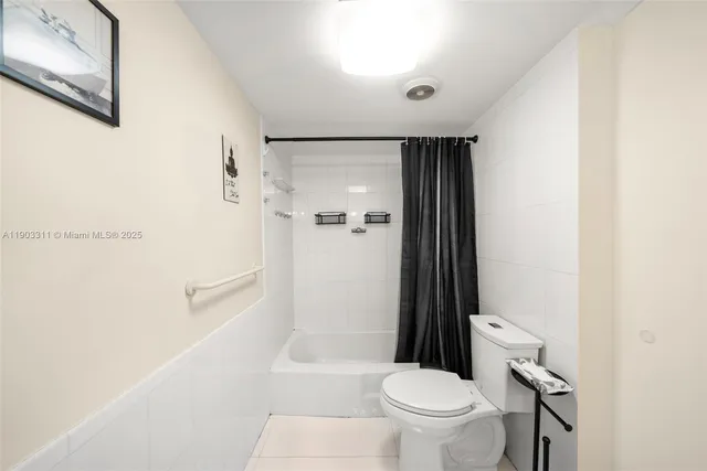 a bed room with a bed and a tv