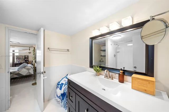 a bathroom with a sink a mirror and a shower