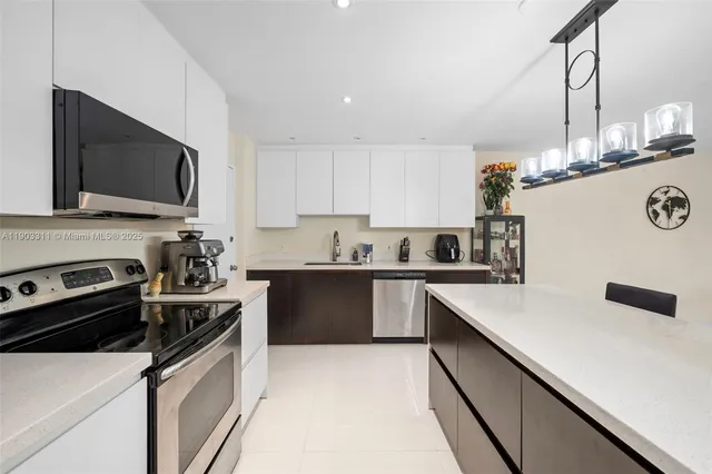 a kitchen that has a sink and a stove top oven