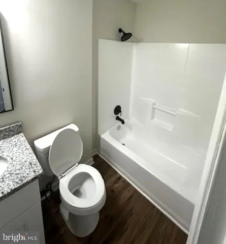 a white toilet sitting next to a bathroom sink