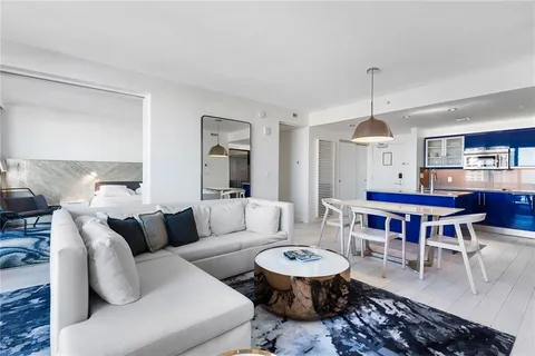 a living room with furniture a rug and a chandelier