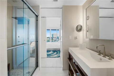 a en suite bathroom with a sink and mirror