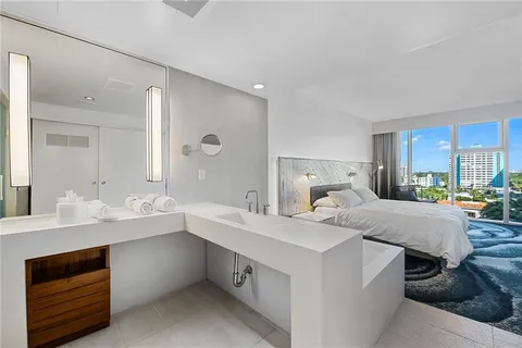 a view of kitchen island a sink and wooden floor