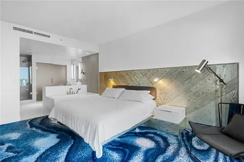 a bedroom with a bed and a mirror