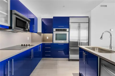 a kitchen with stainless steel appliances granite countertop a refrigerator and a stove top oven