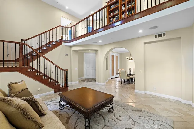 a view of a dining room with furniture and a chandelier