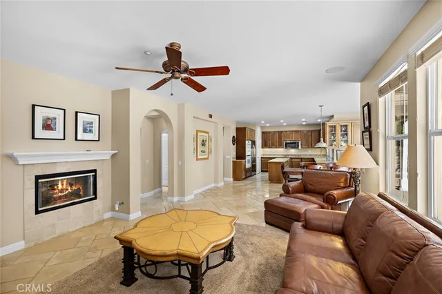 a living room with furniture a window and a chandelier