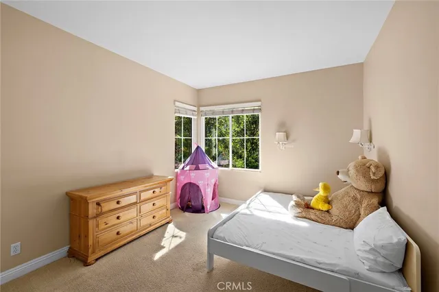 a view of a patio with a dining table and chairs next to a yard