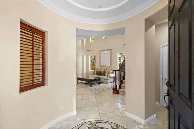 a living room with furniture and a dining table with rug floor