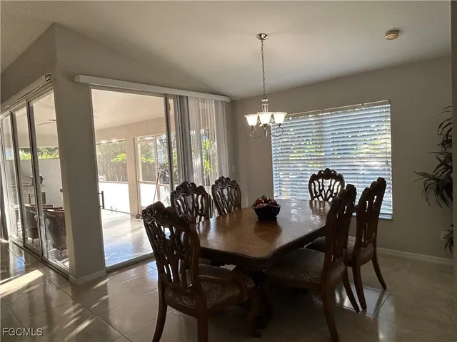 a kitchen with stainless steel appliances kitchen island granite countertop a table and chairs