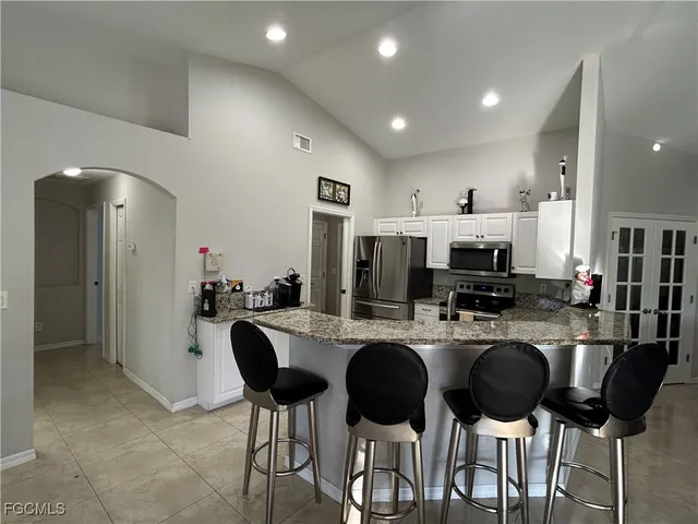 a kitchen with refrigerator and cabinets