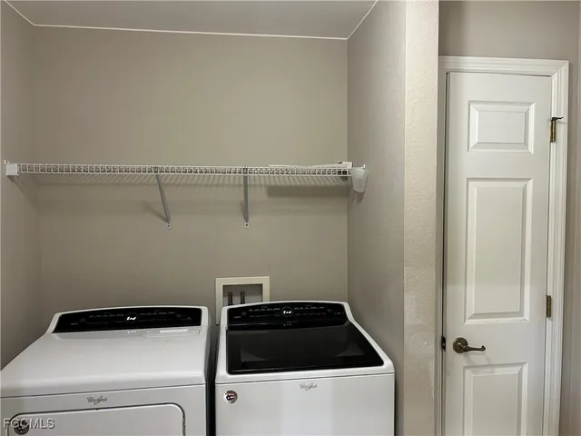 a bathroom with a granite countertop toilet and a sink
