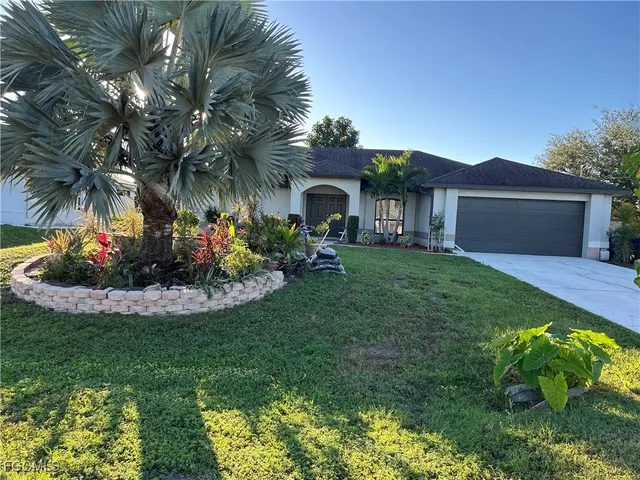 a front view of a house with a garden and plants