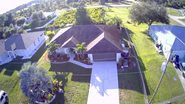 an aerial view of residential house with outdoor space and swimming pool