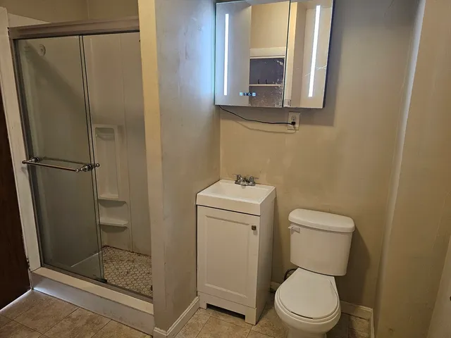 a white toilet sitting next to a bathroom sink