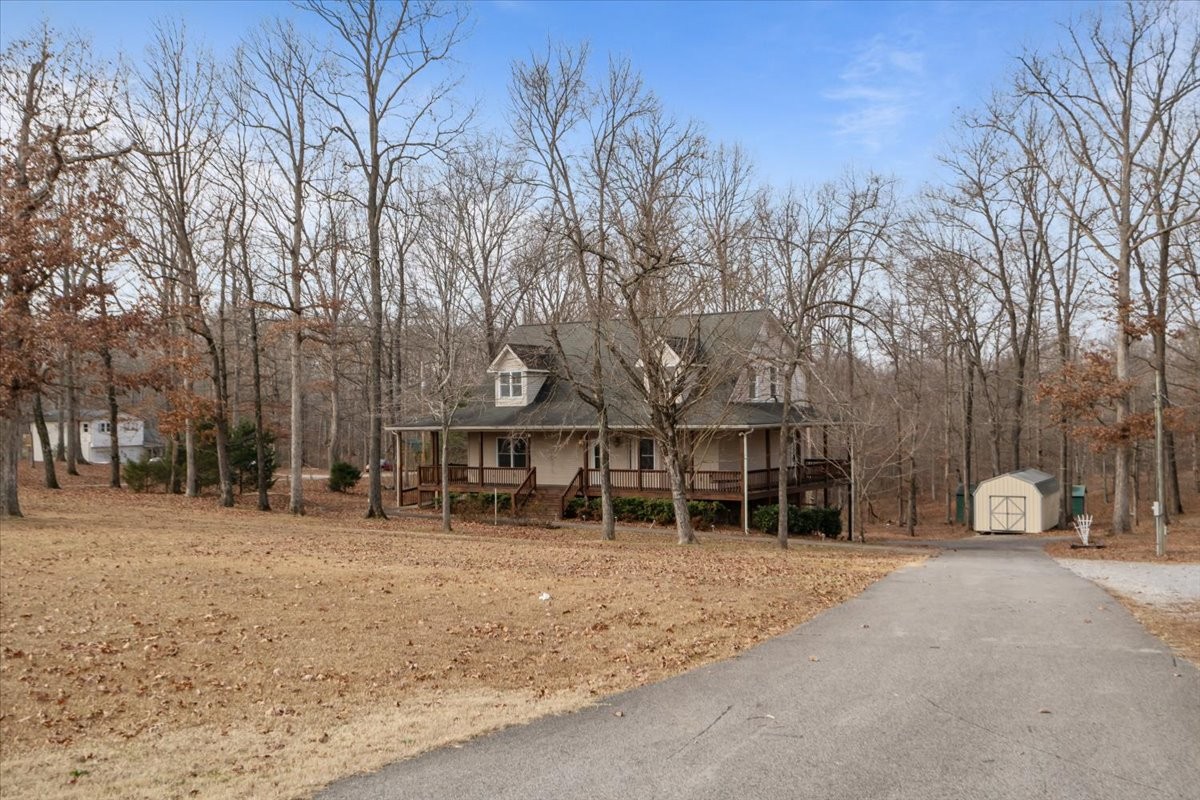 1077 Claylick Road White Bluff, TN 37187 - Photo 2 of 49 a front view of a house with a yard and trees