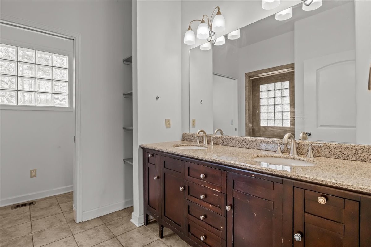1077 Claylick Road White Bluff, TN 37187 - Photo 28 of 49 a bathroom with a granite countertop sink a large mirror and a window