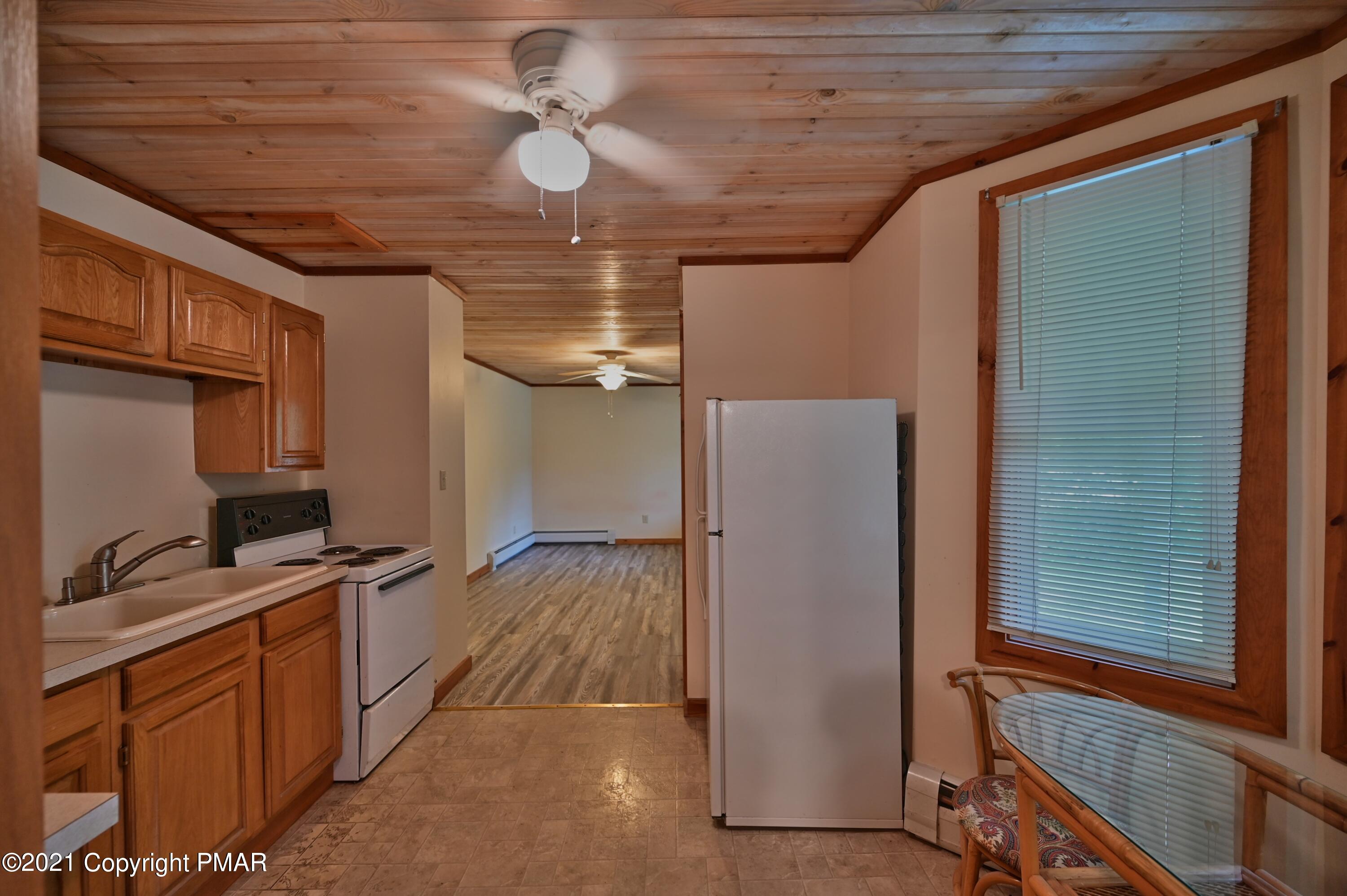 104 Monomonock Road Cresco, PA 18326 - Photo 14 of 83 a kitchen with stainless steel appliances a refrigerator and a stove