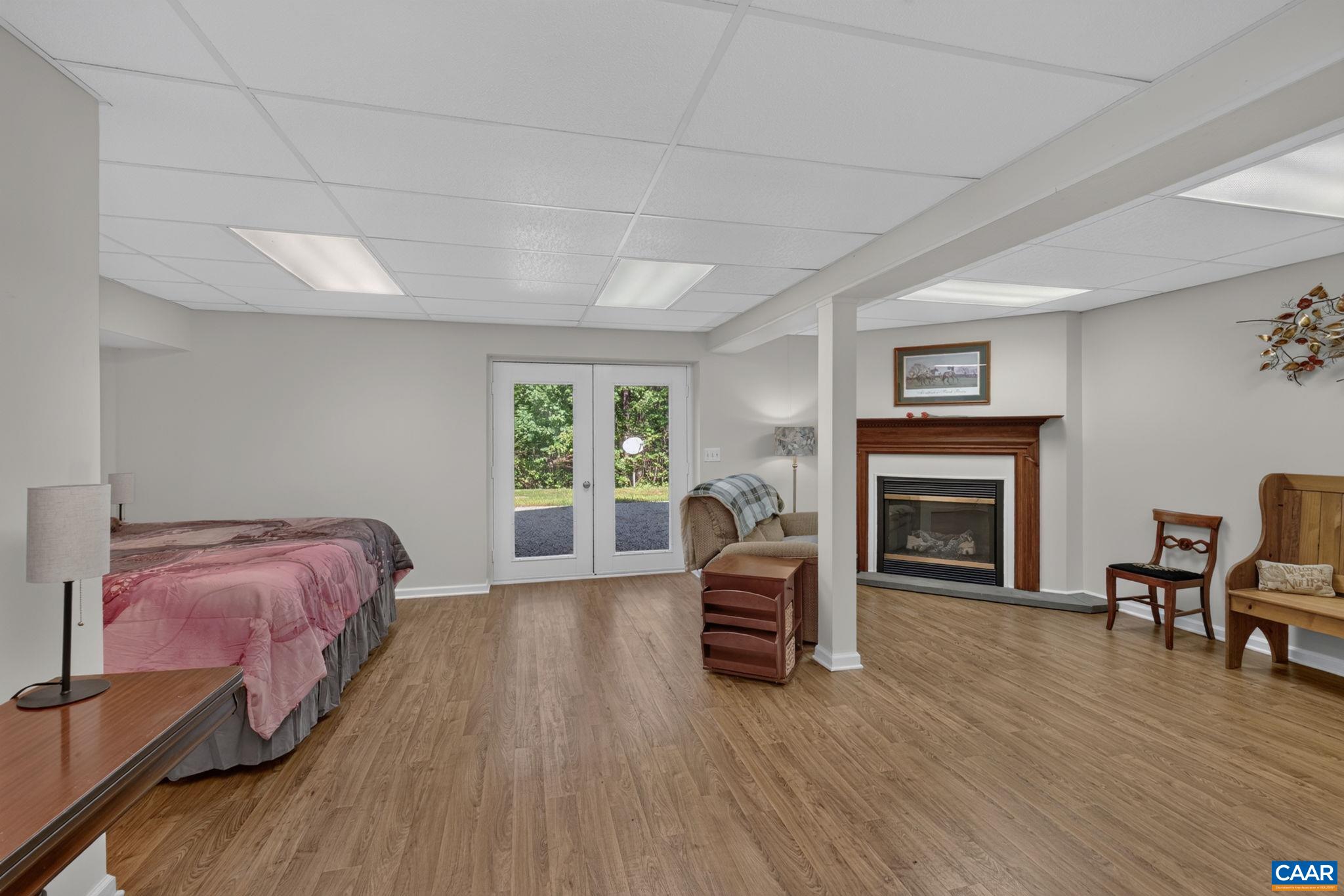 5363 Stony Point Road Barboursville, VA 22923 - Photo 40 of 66 The flooring in this palatial space is brand new (2026). Space could be used as a 4th bedroom, office, play area or whatever...the possibilities are endless. French doors lead out of the walk out basement plus there is a propane gas fueled Fireplace.