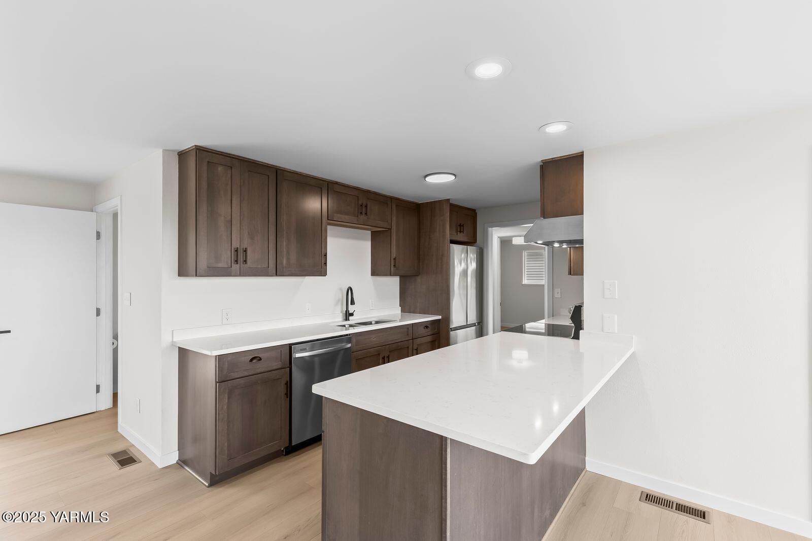 602 Meadowbrook Road Yakima, WA 98903 - Photo 11 of 42 a kitchen with a sink a stove and cabinets