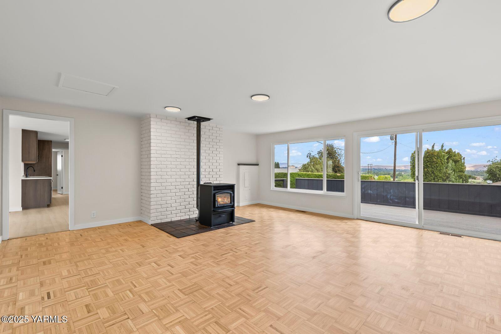 602 Meadowbrook Road Yakima, WA 98903 - Photo 16 of 42 a view of an empty room with a fireplace and a large window