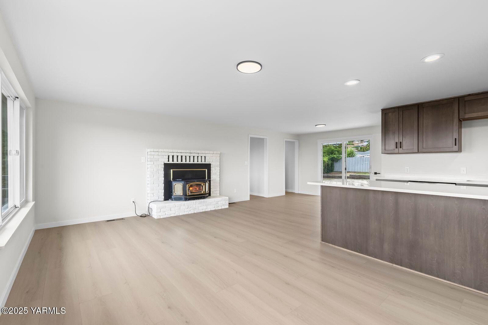 602 Meadowbrook Road Yakima, WA 98903 - Photo 8 of 42 an empty room with wooden floor and fireplace