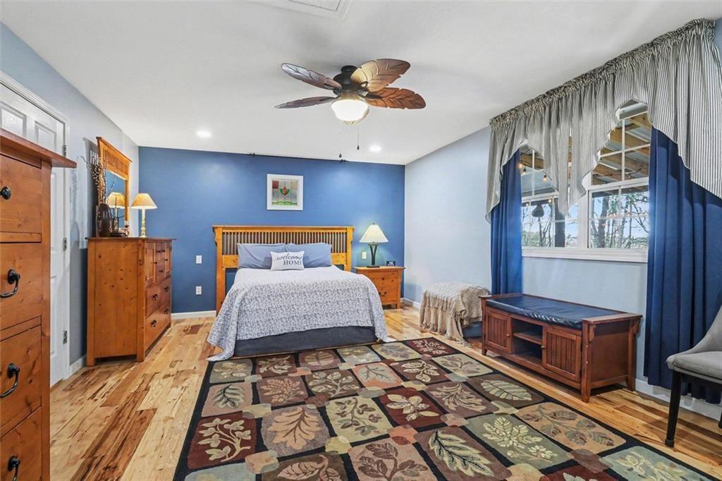 387 Ruby Lane Mineral Bluff, GA 30559 - Photo 14 of 29 a bedroom with a bed and a chandelier