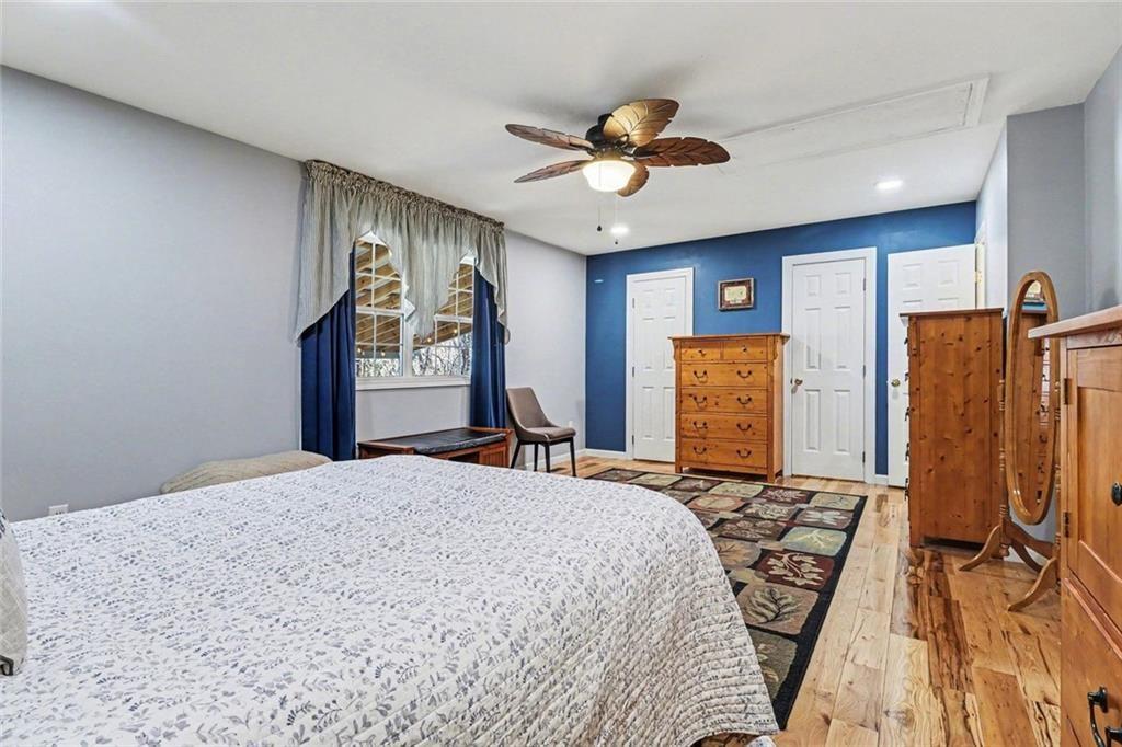 387 Ruby Lane Mineral Bluff, GA 30559 - Photo 15 of 29 a bedroom with a bed dresser and a large mirror
